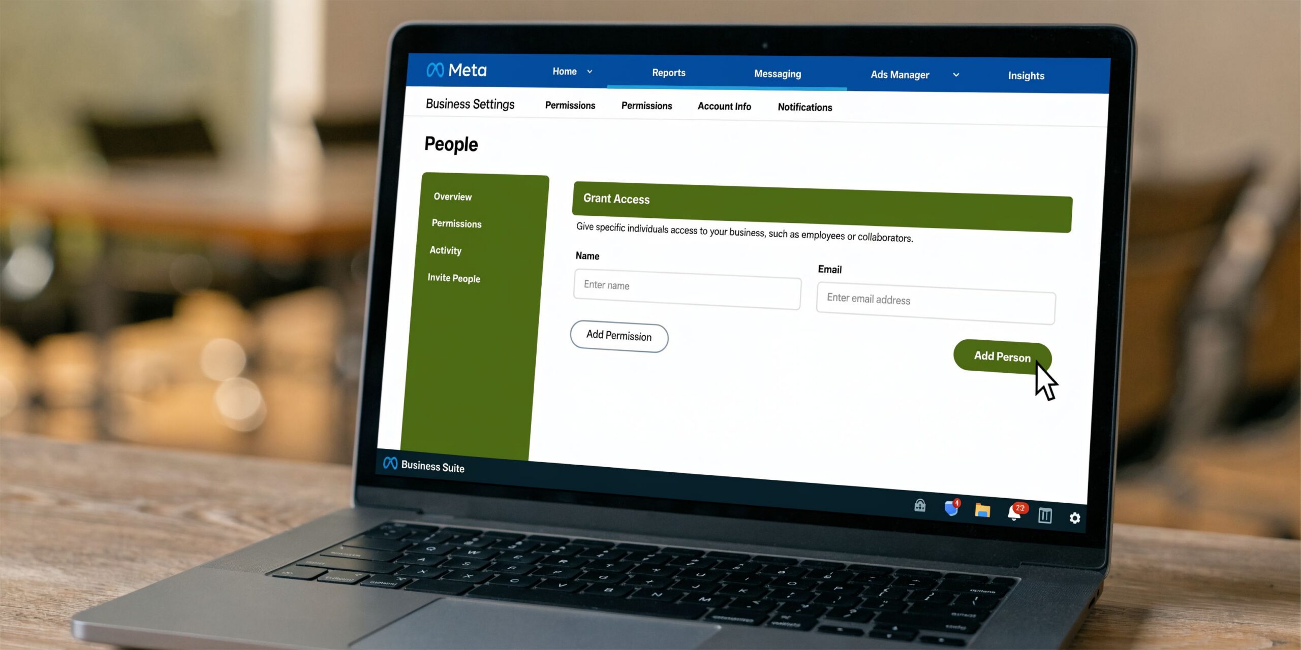 A laptop screen displaying the Meta Business Suite interface for adding a new person to a business account.