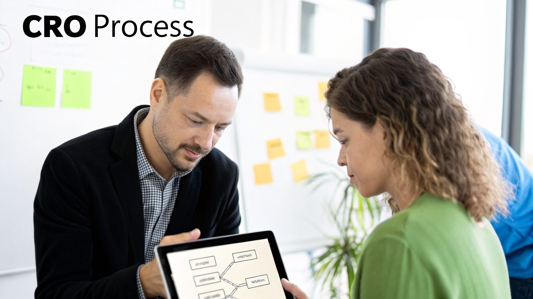Two professionals discuss a CRO process flowchart with a conversion optimization consultant.